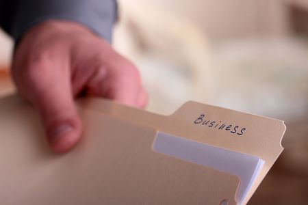 The man the businessman stretches office folder for documents with a mark business.