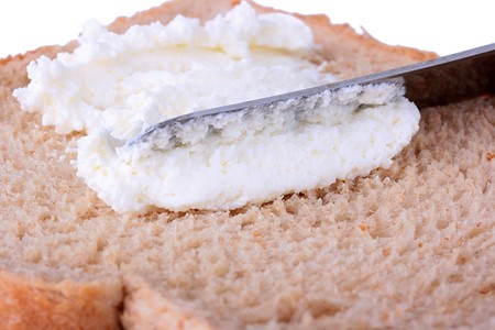 On bread with a knife smear cream cheese.の写真素材