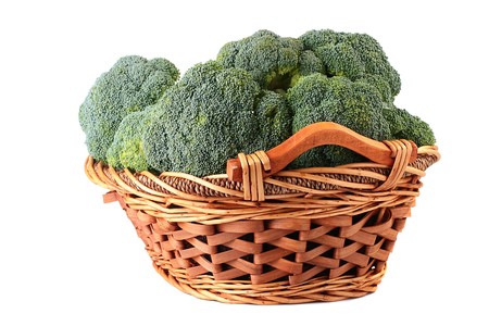 Crop of cabbage of a broccoli in a wattled basket on a white background.の写真素材