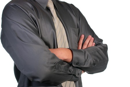 Man Businessman with the crossed hands on a breast in a grey shirt and a tie.の写真素材