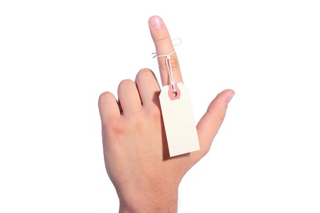 The man's finger specifies a direction, the label is adhered to a finger for the information.の写真素材
