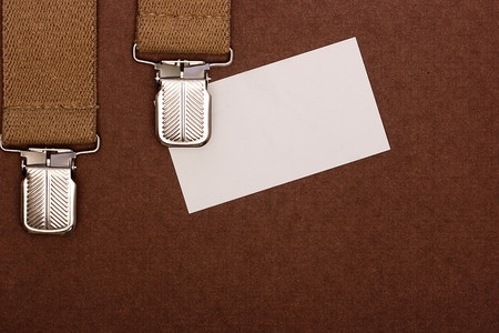 Man's braces about business by a card as a background for design works.の写真素材