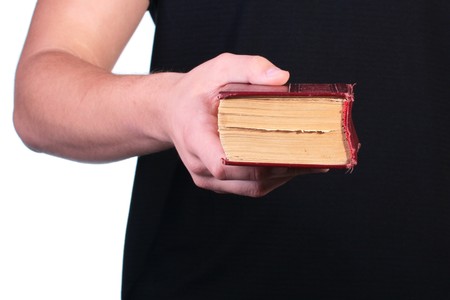 The man offers the old book in firm cover.の写真素材