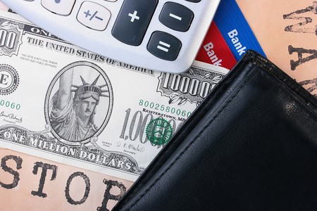The inflation concept, dollar denomination, bank cards, purse and the calculator.の写真素材