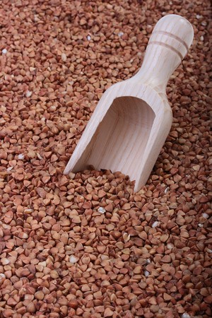 Buckwheat groats with a wooden deep spoon for packaging.の写真素材