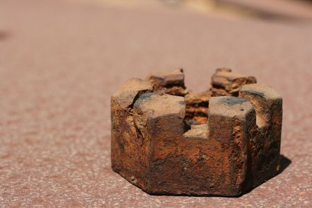 The old rusty worn out nut with a special surface for its fixing.の写真素材