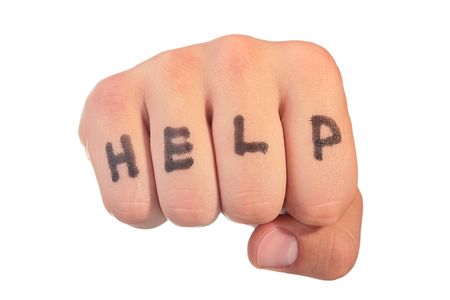 On a man's fist word Help is written.の写真素材