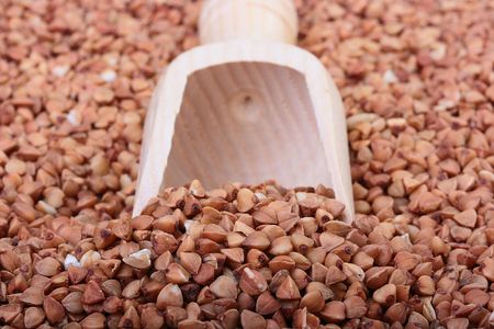 Buckwheat groats with a wooden deep spoon for packaging.の写真素材