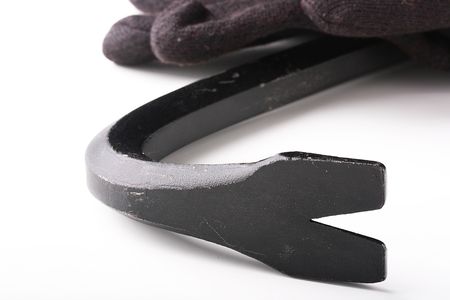 The tool used at destruction of old structures and at larceny - crowbar with black gloves.の写真素材