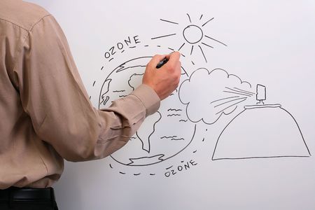 Man in a brown shirt drawing what could happen to the earth's ozone layer.の写真素材