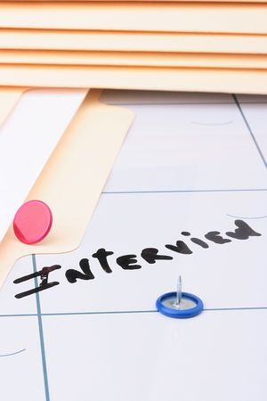 The information on a calendar about interview with office accessories.の写真素材