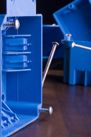 Blue switch box on a wooden surface.の写真素材