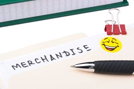 A merchandise folder with a pen and a yellow smiley on it.の写真素材