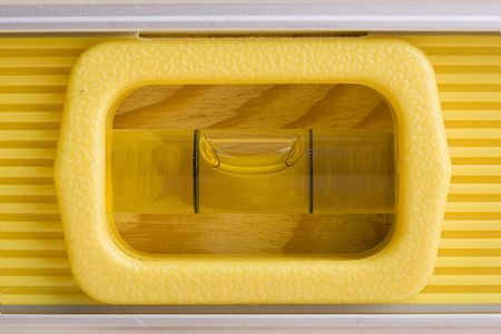 Close-up of a yellow bubble level in balance.