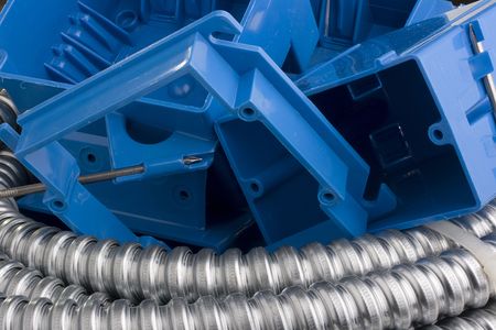 Many switch boxes laying next to a metal cable.の写真素材