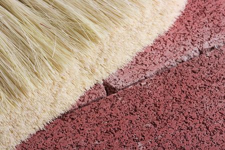 Stonemason's brush on a red brick background.の写真素材