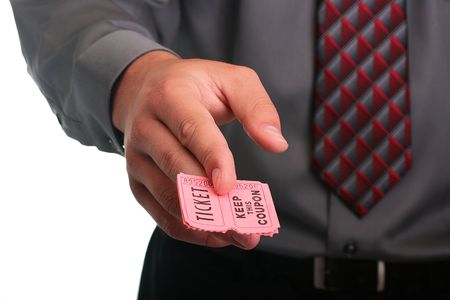 The businessman in a grey shirt and a tie stretches the ticket with the coupon.