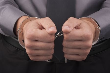 Arrest, close-up shot man's hands with handcuffs.