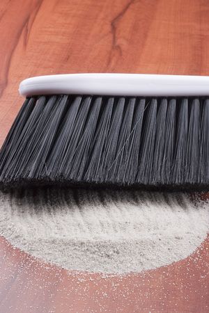 House cleaning, on a floor small sand simulating dust is scattered.の写真素材