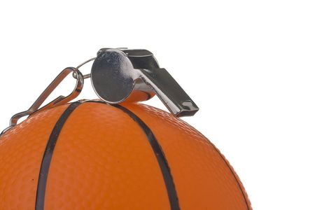 A silver whistle laying on an orange basketball. Add your text to the background.の写真素材