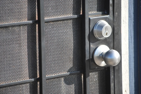 Door lock with a round metal handle on the door.の写真素材