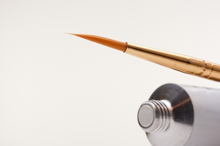 Tube of paint and a brush to paint.の写真素材