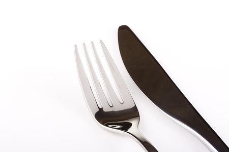 Knife and fork on a white background - tableware.の写真素材