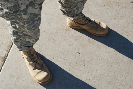 Soldier in camouflage pants and army boots.