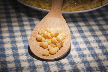 Canned corn in a wooden spoon chef.の写真素材