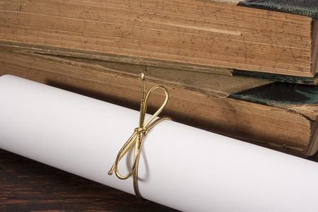 Certificate of graduation tied a gold ribbon.の写真素材