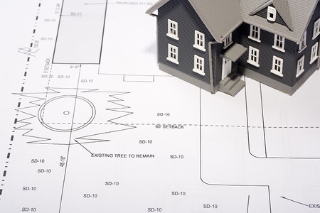 House model on a plan of a house construction.