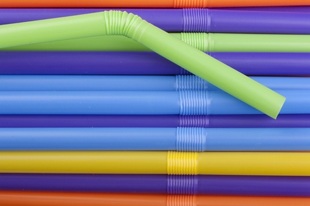 Plastic tubes of different colors in the background.