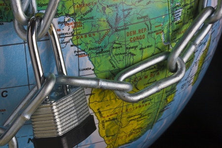 Metal lock and chain on a globe.の写真素材