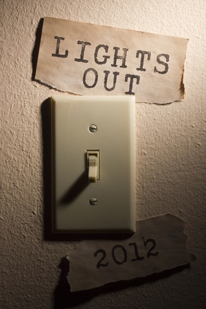 Old papers next to a light switch that say 2012 and Lights Out representing the end of the world.の写真素材