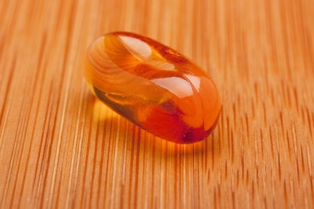 Medical pill against diseases on a wooden table.の写真素材