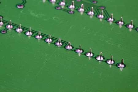 Close-up photograph of a green circuit board.