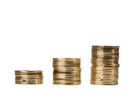 Stacks of golden coins isolated on a white background.の写真素材