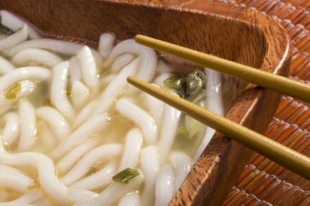 Asian noodle soup in a brown wooden bowl.の写真素材