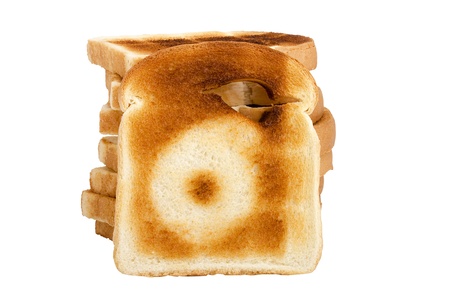 Number 6 burnt on a slice of white bread isolated on a white background.の写真素材