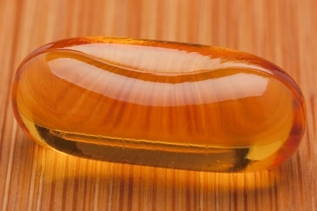 Medical pill against diseases on a wooden table.の写真素材