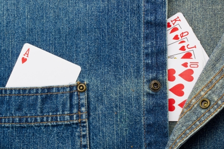 Close-up photograph of playing cards on denim material.の写真素材