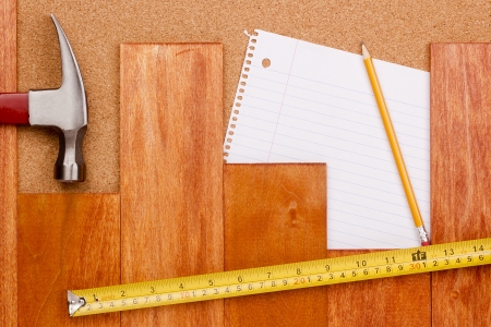 Industrial background with a wooden hammer and measuring tape.の写真素材