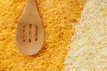 Two varieties of cheese finely grated with a wooden spoon.の写真素材