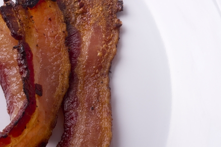 Fried bacon - an ingredient in many dishes. Macro.