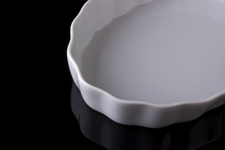 White ceramic plate on a black background.の写真素材