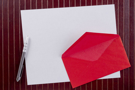 Background with sheet of paper and pen red envelopeの写真素材