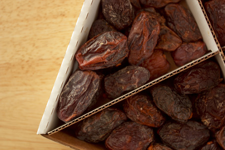 Smoked date palm fruits in a carton box.の写真素材