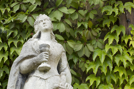 Stone sculpture of a woman with a cup and a sword in the historical complex Radomishl Zhytomyr Oblast, Ukraine, summer 2014.の写真素材