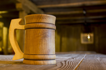 Wooden mug on a table in a tavern.の写真素材