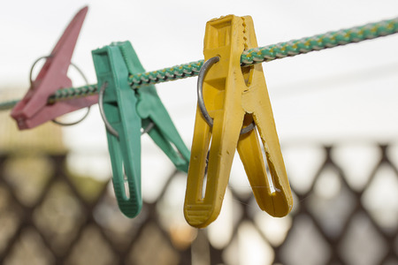Old colorful linen plastic clothespins on a rope.